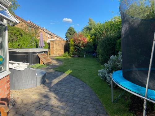 a backyard with a hot tub and a garden at Beautiful 3 Bedroom Detached home with hot tub in Fisherrow