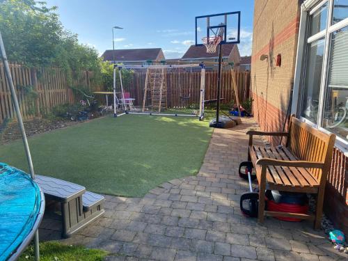a backyard with a basketball court and a basketball hoop at Beautiful 3 Bedroom Detached home with hot tub in Fisherrow