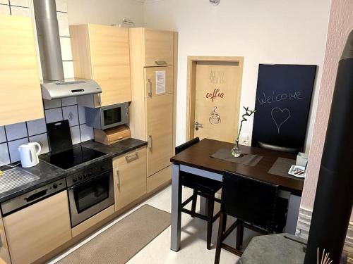a kitchen with a table and a stove top oven at Naturnah in Hellenthal in Hellenthal