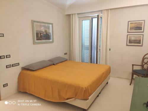 a bedroom with a bed in a room with a window at Villino La Canfora in Ischia