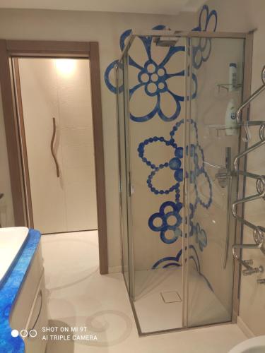 a shower with a glass door in a bathroom at Villino La Canfora in Ischia