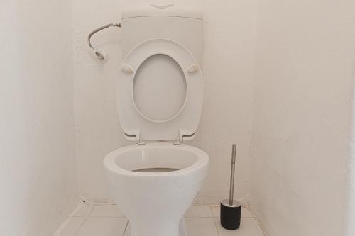 a white toilet with the seat up in a bathroom at Welcoming 2BR Apt. near AKH- Perfect for Longstays in Vienna