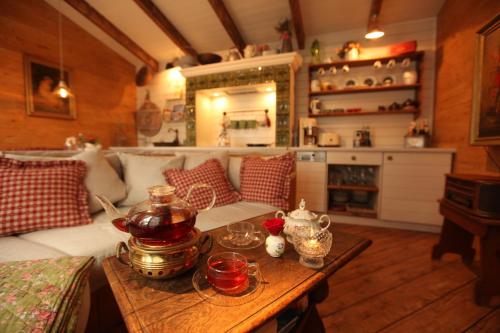 a living room with a couch and a table at Weißt Du noch - Gästehäuser & Suiten in Kühlungsborn