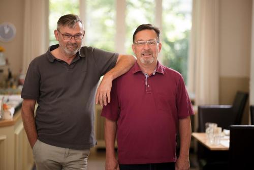 two men are standing next to each other at Hotel Minerva in Freiburg im Breisgau