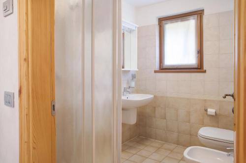 a bathroom with a toilet and a sink at Casa Vacanza La Rocca Bilocale in Chiesa in Valmalenco