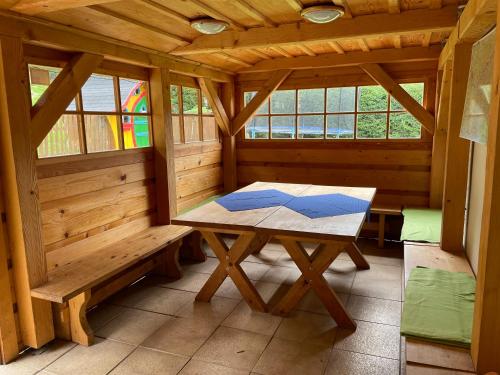 a wooden sauna with a table in the middle at Apartments Ve dvoře in Velké Karlovice