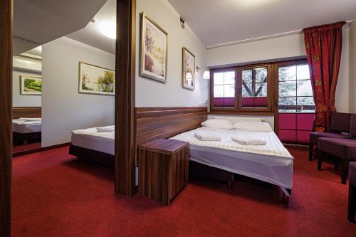 a small room with two beds and a window at Leśne Patio in Katowice