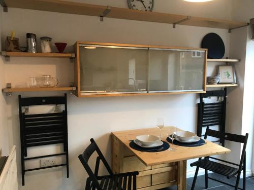 a kitchen with a wooden table with two bowls on it at Riverside home. 3 bedroom. Free parking. 10 mins to Newcastle City Centre in Dunston