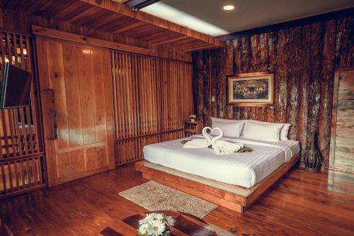 a bedroom with a bed with a bow on it at Andalay Beach Resort Koh Libong in Ko Libong