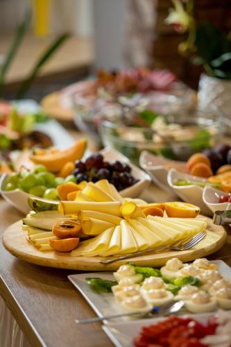 a table with many plates of food on it at Pensjonat Śnieżka SPA in Karpacz