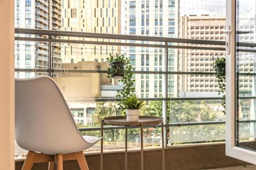 a white chair and a table in front of a window at Oakdale at Centrium in Woking