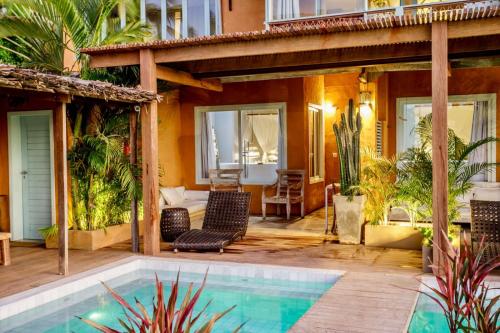a house with a swimming pool and a patio at Pousada Mi Secreto in São Miguel do Gostoso
