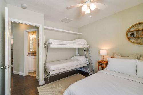 a bedroom with two bunk beds and a ceiling fan at Luxury home in the heart of South Tampa & POOL! in Tampa