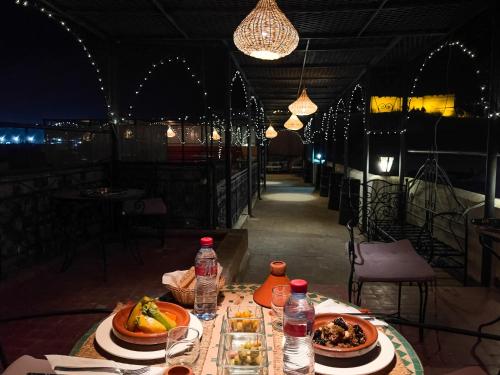 a table with plates of food on top of it at Riad Pacha Palace in Fès