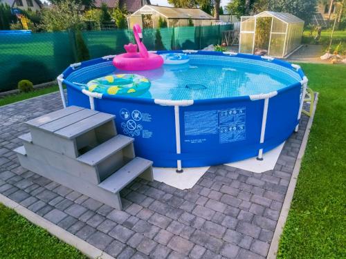 a pool in a yard with a table and a bench at Szary Domek w Karkonoszach in Podgórzyn