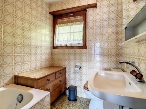 een badkamer met een wastafel, een bad en een toilet bij Crépuscule 5 in Verbier