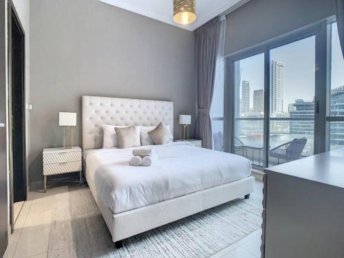 a bedroom with a large bed and a large window at Key View - Bay Central in Dubai