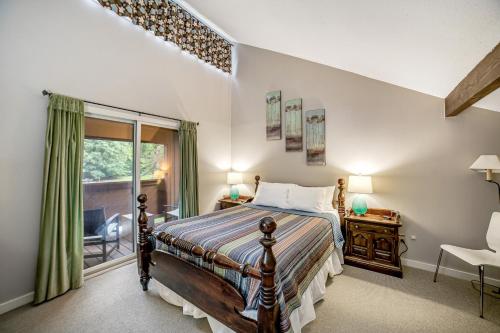 a bedroom with a bed and a window at Sugar Run: 25 in Sugarbush Village