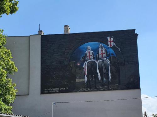 a large billboard with two soldiers on the side of a building at Hostel Zacisze 2 in Głubczyce