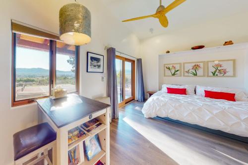 a bedroom with a bed and a large window at Cottam Pines B - Permit #9228 in Taos