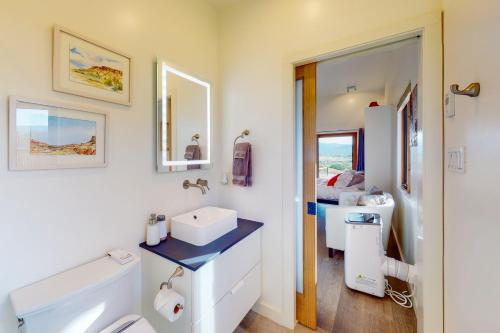 a white bathroom with a sink and a toilet at Cottam Pines B - Permit #9228 in Taos