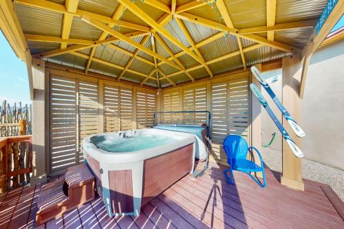 a bathroom with a tub and a bed on a deck at Cottam Pines B - Permit #9228 in Taos