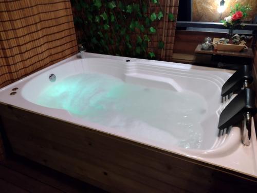 a bath tub filled with water in a bathroom at EUCALYPTO CHALET in Guarne