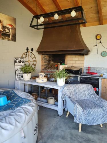 a kitchen with a stove and a table with plants at A l'Ecole Buissonnière, chambre d'hôtes en Sidobre in Lacrouzette