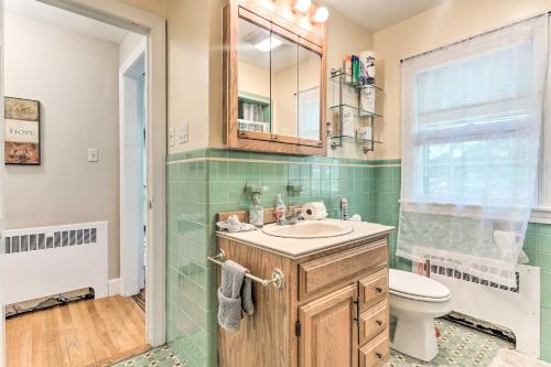 a bathroom with a sink and a toilet and a mirror at Grand Worcester Getaway with Large Private Yard! in Worcester