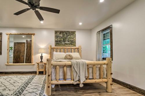 a bedroom with a bed and a ceiling fan at Pet-Friendly Delta Cabin with Private Hot Tub! in Delta
