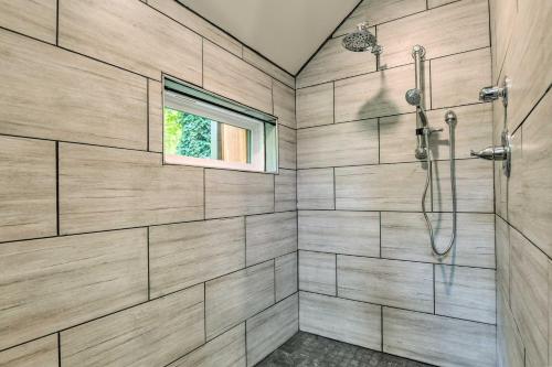 a bathroom with a shower and a window at Pet-Friendly Delta Cabin with Private Hot Tub! in Delta