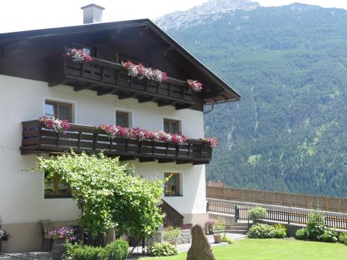 a white building with flowers on the balconies at Apartment Fischer in Tarrenz