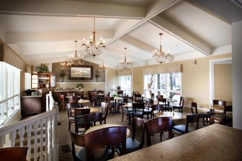 a dining room with tables and chairs and chandeliers at Grant Street Inn - Bloomington in Bloomington