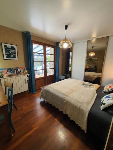 a bedroom with a large bed and a window at A l'Ecole Buissonnière, chambre d'hôtes en Sidobre in Lacrouzette