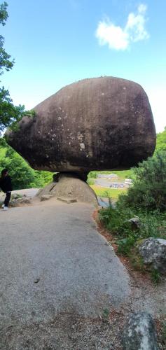 a large rock sitting on the side of a road at A l'Ecole Buissonnière, chambre d'hôtes en Sidobre in Lacrouzette
