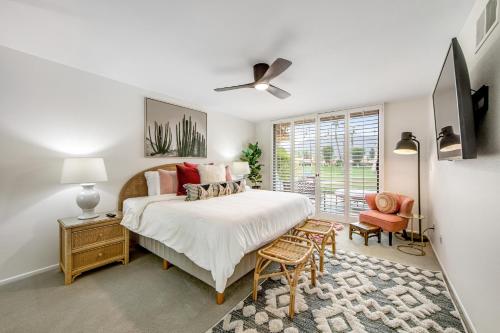 a bedroom with a large bed and a window at Sunshine On My Shoulders Permit# STR2022-0160 in Palm Desert