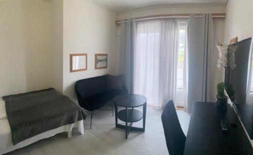 a living room with a bed and a table at Sunde Fjord Hotel, free and easy parking in Solavagen