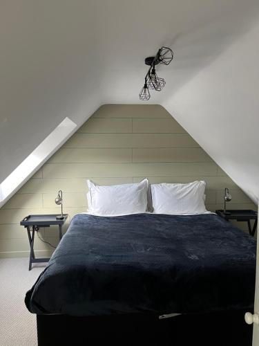 1 dormitorio con 1 cama negra y 2 mesas en Luxury stay Kings Annexe 5 minutes from Longleat en Warminster