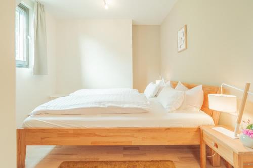 a bed with white sheets and pillows in a bedroom at Hotel Restaurant zur Sonne St. Peter in Sankt Peter