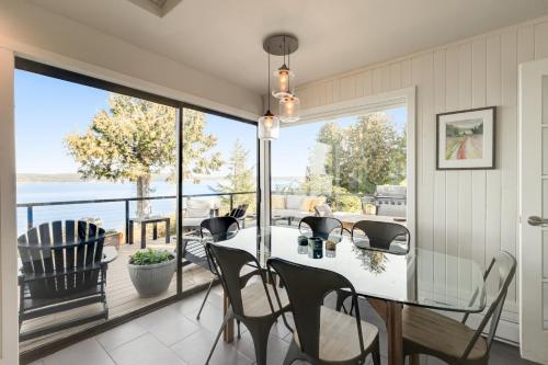 a dining room with a view of the water at Saratoga Waterview Escape in Langley