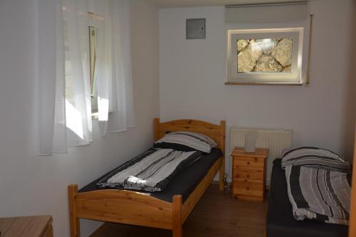 a bedroom with two beds and a picture on the wall at Ferienwohnung Christina in Ursensollen