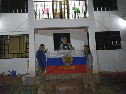 a group of men holding a flag in a building at Hospedaje Casa Blanca in Guatavita