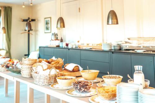 a table with baskets of food and plates on it at Hotel Restaurant zur Sonne St. Peter in Sankt Peter