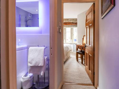 a bathroom with a sink and a toilet and a tub at Squint Cottage in Skipton