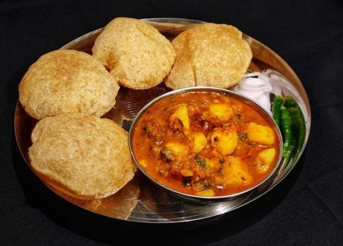 a plate of food with a bowl of soup and biscuits at Sukh Sagar Hotel in Jaipur