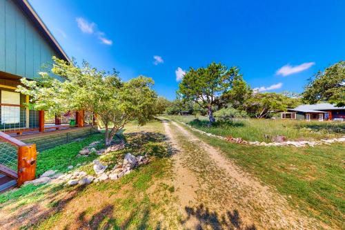 a dirt road in front of a house at Cabin-Style Book House & Writing Barn in Austin