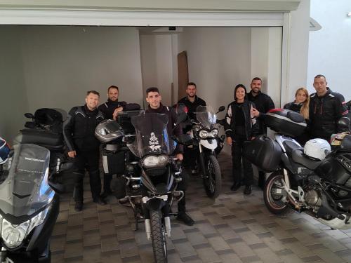 a group of people standing in a room with motorcycles at Bed and Breakfast Majesty in Niš