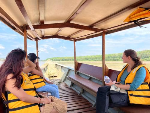 a group of people sitting on a boat at Hacienda Herrera Tambopata in Puerto Maldonado