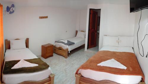 Een bed of bedden in een kamer bij Hotel la Victoria