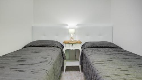 two beds sitting next to each other in a bedroom at Puerto Centro in Puerto del Rosario